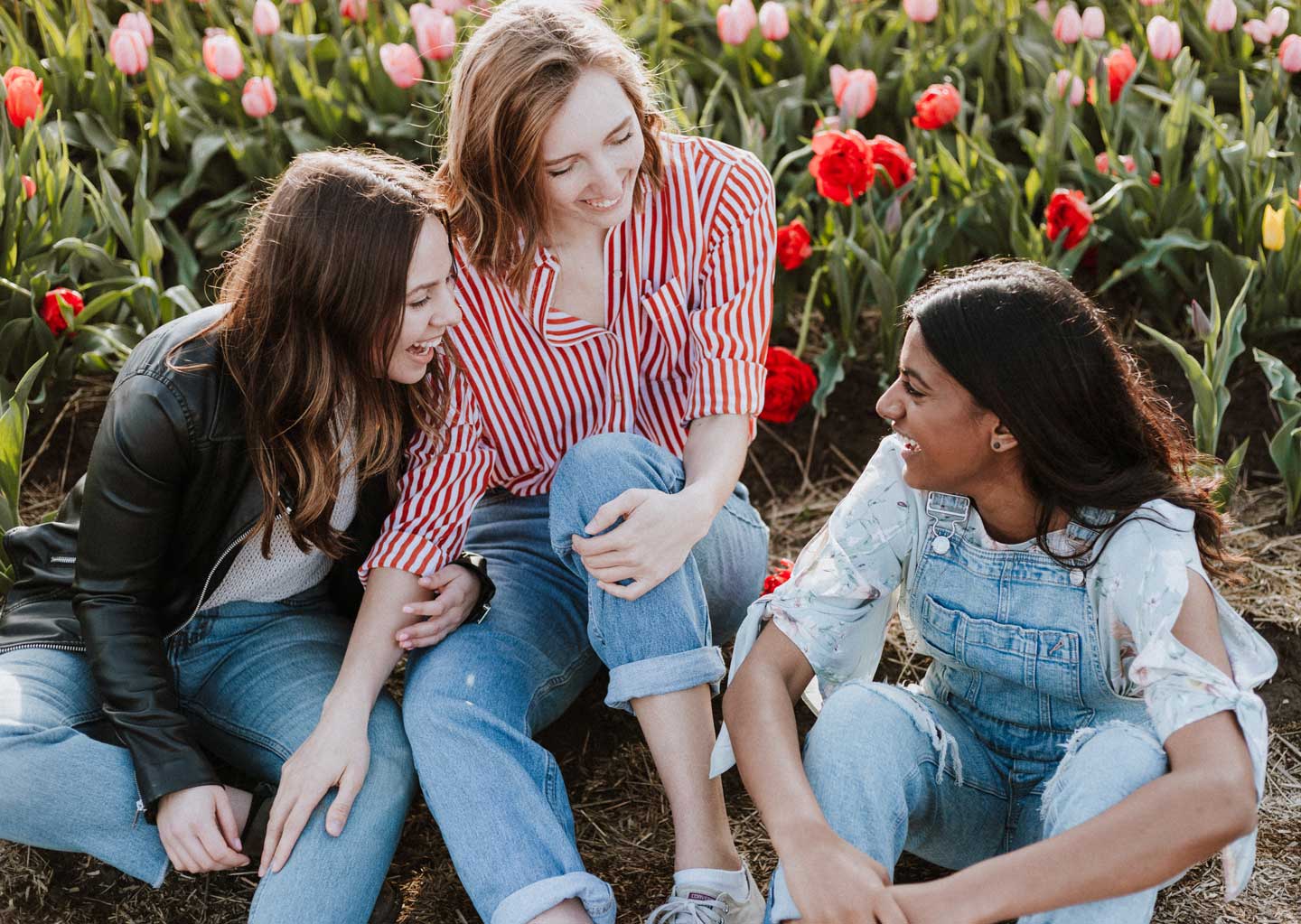 three young women talking and laughing